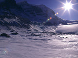sun shines through the valley of snow