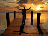 man worshiping God at sunset